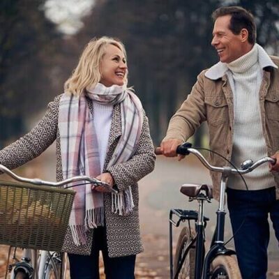 man and woman walking their bikes
