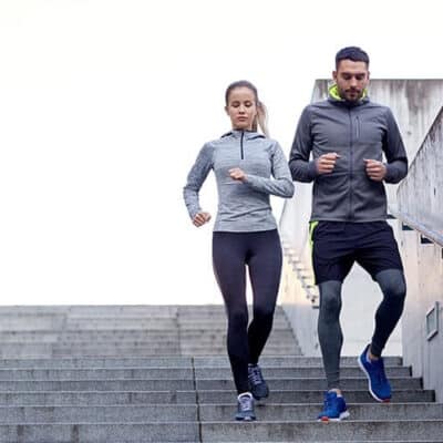 couple jogging down a flight of stairs